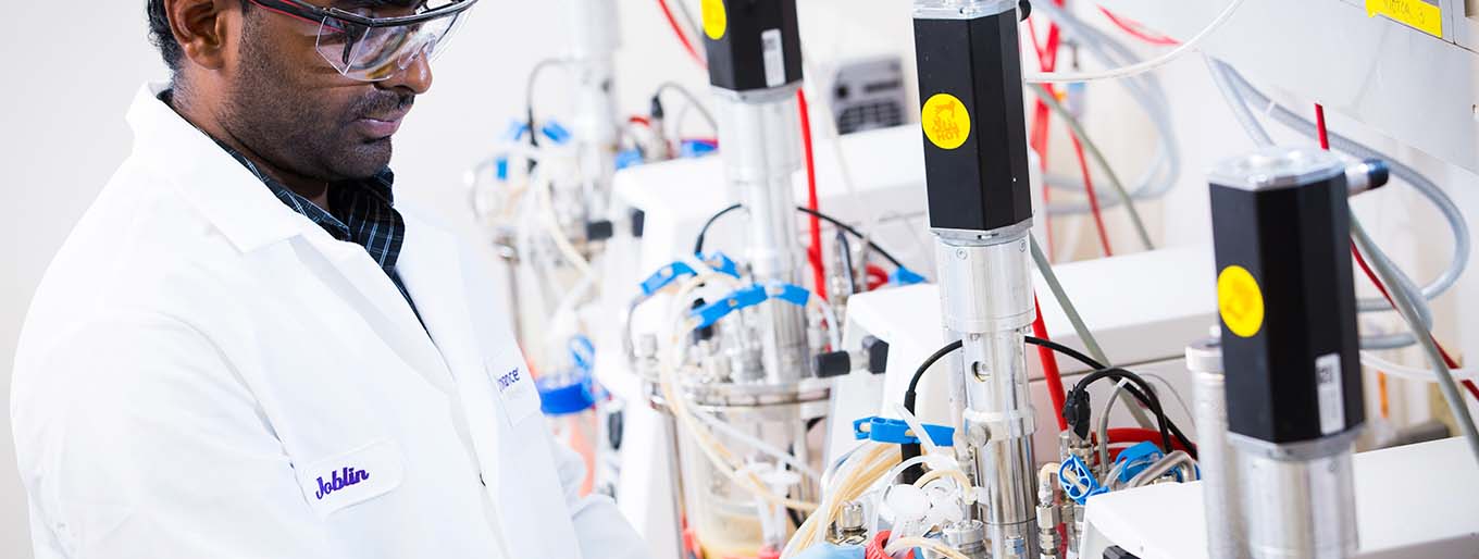 A Cytovance scientist working in an microbial process development lab.