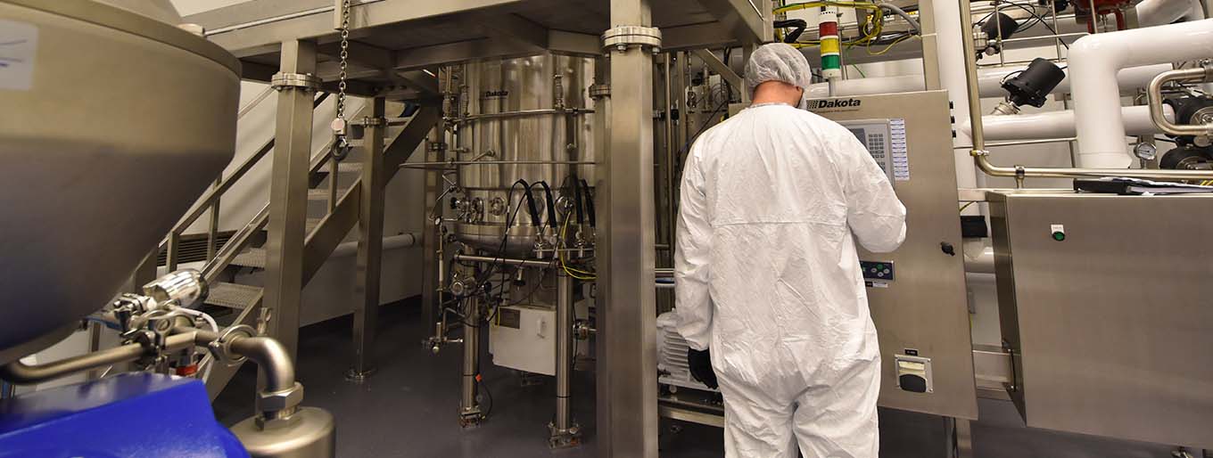 Cytovance microbial CDMO expert working in 1000L fermenter.